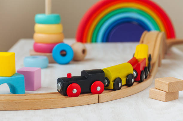 Wooden toys concept. Wooden toy railway and pyramid in the children room.